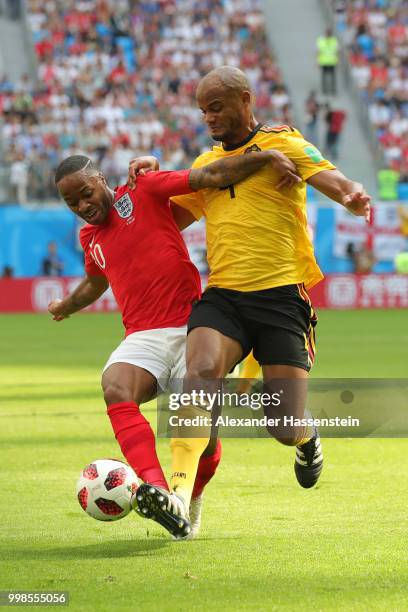 Vincent Kompany of Belgium challenges Raheem Sterling of England during the 2018 FIFA World Cup Russia 3rd Place Playoff match between Belgium and...