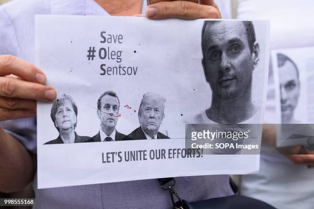 Poster with portraits of German Chancelor, Angela Merkel, French President, Emmanuel Macron and United States Of America President, Donald Trump...