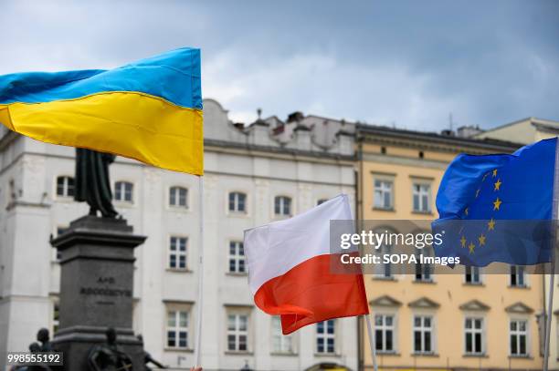 Ukrainian, Polish and European Union flags are seen during the protest. Protest demanding the release of the Ukrainian filmmaker and writer, Oleg...