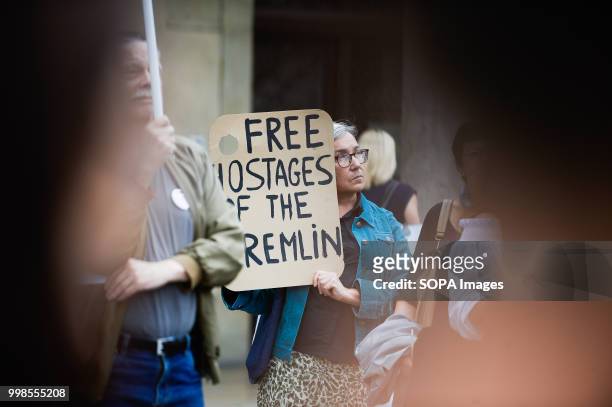 Woman holds a poster saying Free Hostages of the Kremlin during the protest. Protest demanding the release of the Ukrainian filmmaker and writer,...