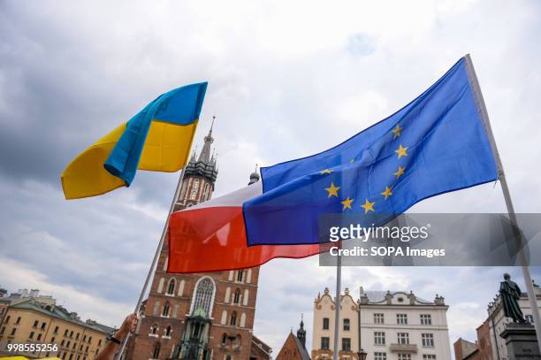 Ukrainian, Polish and European Union flags are seen during the protest. Protest demanding the release of the Ukrainian filmmaker and writer, Oleg...