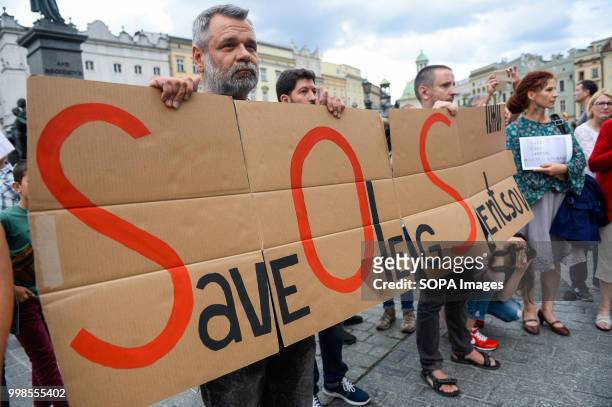 Man holds a banner saying Save Oleg Sentsov during the protest. Protest demanding the release of the Ukrainian filmmaker and writer, Oleg Sentsov at...