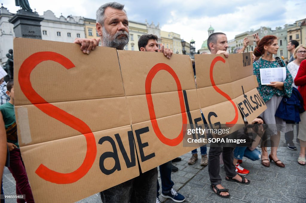 A man holds a banner saying Save Oleg Sentsov during the...