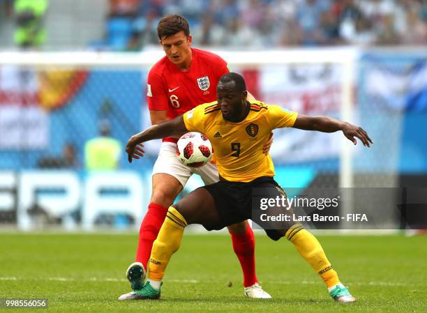 Romelu Lukaku of Belgium is challenged by Harry Maguire of England during the 2018 FIFA World Cup Russia 3rd Place Playoff match between Belgium and...