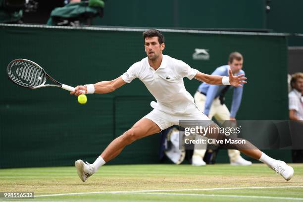 Novak Djokovic of Serbia returns against Rafael Nadal of Spain during their Men's Singles semi-final match on day twelve of the Wimbledon Lawn Tennis...