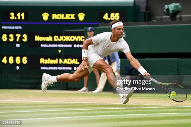 Rafael Nadal of Spain returns against Novak Djokovic of Serbia during their Men's Singles semi-final match on day twelve of the Wimbledon Lawn Tennis...