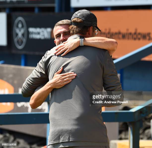 Jurgen Klopp manager of Liverpool embraces Ryan Lowe manager of Bury before the Pre-Season friendly match between Bury and Liverpool at Gigg Lane on...