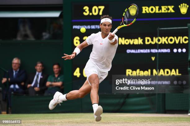 Rafael Nadal of Spain returns against Novak Djokovic of Serbia during their Men's Singles semi-final match on day twelve of the Wimbledon Lawn Tennis...