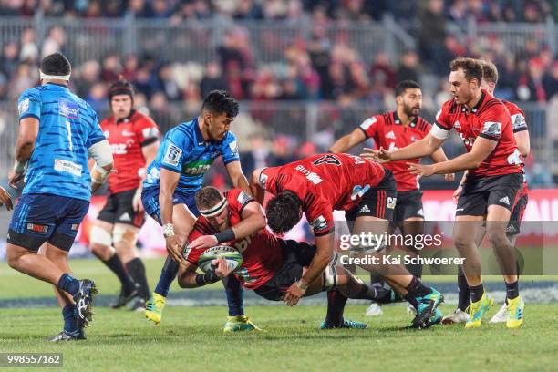 Kieran Read of the Crusaders is tackled during the round 19 Super Rugby match between the Crusaders and the Blues at AMI Stadium on July 14, 2018 in...