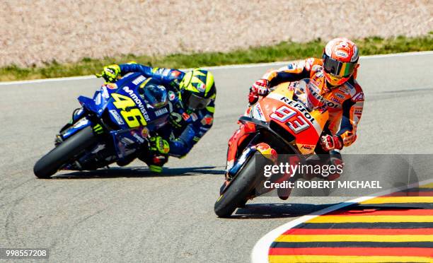 Spanish Honda rider Marc Marquez and Italian Yamaha rider Valentino Rossi compete in the training session of the Moto GP for the Grand Prix of...