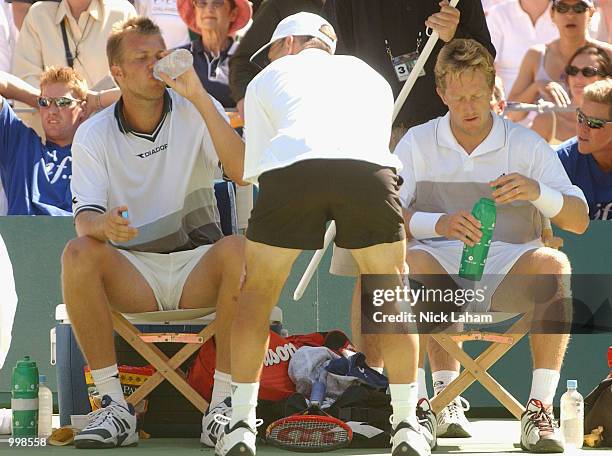 Magnus Larsson and Jonas Bjorkman of Sweden between games against Todd Woodbridge and Wayne Arthurs of Australia in the Davis Cup Semi Final match...