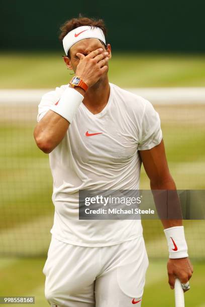 Rafael Nadal of Spain appears dejected during his Men's Singles semi-final match against Novak Djokovic of Serbia on day twelve of the Wimbledon Lawn...