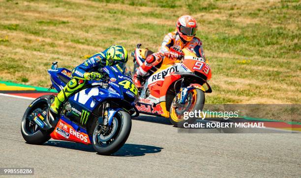 Spanish Honda rider Marc Marquez and Italian Yamaha rider Valentino Rossi compete in the training session of the Moto GP for the Grand Prix of...