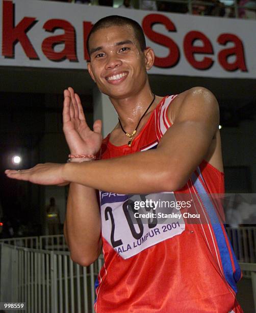 Reanchai Seerharwong of Thailand does a Ultraman symbol after he won the Men's 100m Final of the Track & Field Event held at the National Stadium,...