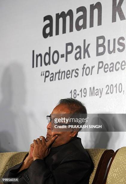 Indian Finance Minister Pranab Mukherjee gestures while listening to the speech of Pakistan's High Commissioner to India Shahid Malik during Indo-Pak...