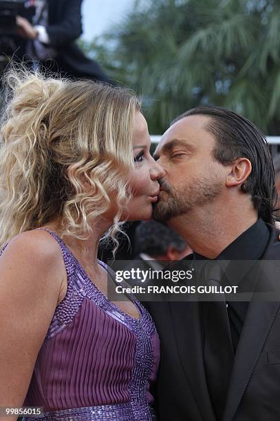 French former tennis player Henri Leconte kisses his wife Florentine as they arrive for the screening of "Biutiful" presented in competition at the...