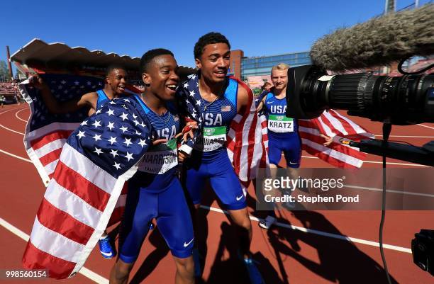 Eric Harrison, Anthony Schwartz, Austin Kratz and Micah Williams of The USA celebrate winning gold in the final of the men's 4x100m relay on day five...