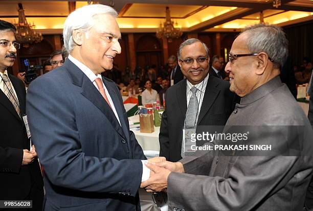 India Finance Minister Pranab Mukherjee shakes hands with Pakistan's High Commissioner to India Shahid Malik during Indo-Pak Business meet in New...