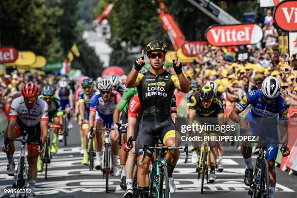 Netherlands' Dylan Groenewegen celebrates as he crosses the finish line ahead of Germany's Andre Greipel and Colombia's Fernando Gaviria to win the...