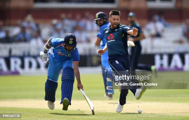 Mark Wood of England kicks at the ball to try to run out Shikhar Dhawan of India during the 2nd ODI Royal London One-Day match between England and...