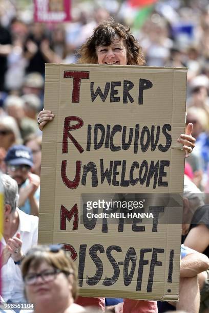 Protester holds up a placard as she takes part in the Scotland United Against Trump demonstration through the streets of Edinburgh, Scotland on July...