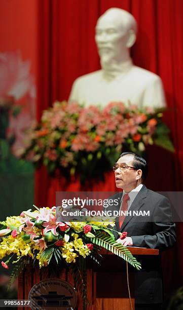 Vietnamese Communist Party Secretary General Nong Duc Manh delivers a speech in front of a bust of late president Ho Chi Minh during a meeting in...