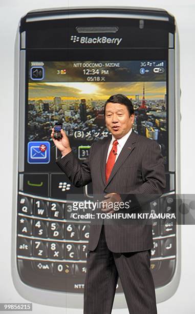 Japanese mobile operator NTT DoCoMo president Ryuji Yamada, introduces the company's new smartphone, BlackBerry Bold 9700, during their summer...