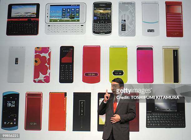Japanese mobile operator NTT DoCoMo president Ryuji Yamada introduces the company's new Windows Mobile-OS smartphone, dynapocket, T-01B during their...