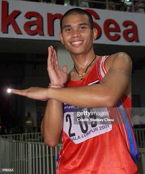 Reanchai Seerharwong of Thailand does a Ultraman symbol after he won the Men's 100m Final of the Track & Field Event held at the National Stadium,...