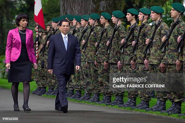 Swiss President Doris Leuthard walks with her Vietnamese counterpart Nguyen Minh Triet as they inspect a guard of honour upon his arrival for an...