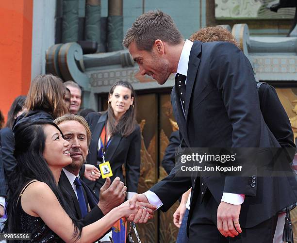 Actor Jake Gyllenhaal, actor Nicolas Cage and wife Alice Kim Cage attend the Handprint And Footprint Ceremony Honoring Producer Jerry Bruckheimer at...