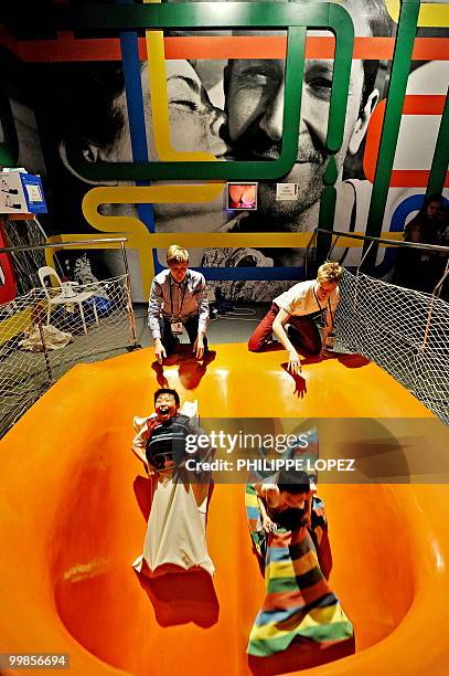 Visitors enjoy a slide inside the Swedish pavilion at the site of the World Expo 2010 in Shanghai on May 18, 2010. Organisers expect 70 million...