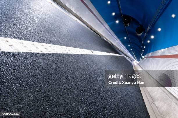 modern highway tunnel underpass - innere ruhe und blau stock-fotos und bilder