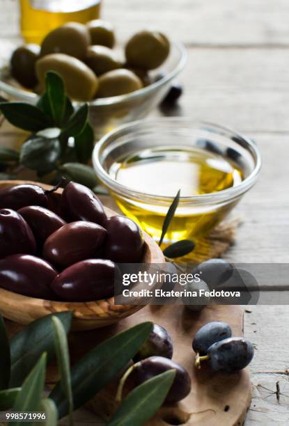 olive oil and olives on wood background - oil on wood stock pictures, royalty-free photos & images