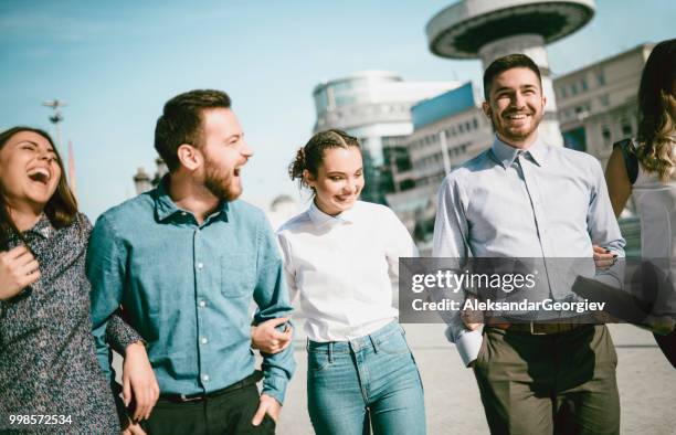 business friends taking a walk after work in city center - aleksandar georgiev stock pictures, royalty-free photos & images