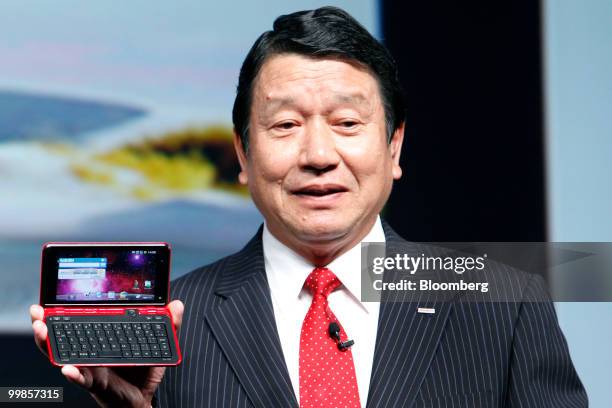 Ryuji Yamada, president of NTT DoCoMo Inc., holds the company's new LYNX SH-10B smartphone running Google Inc.'s Android operating system,...