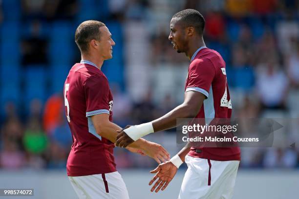 Jonathan Kodjia of Aston Villa is congratulated by James Chester following his goal during the Pre-season friendly between AFC Telford United and...