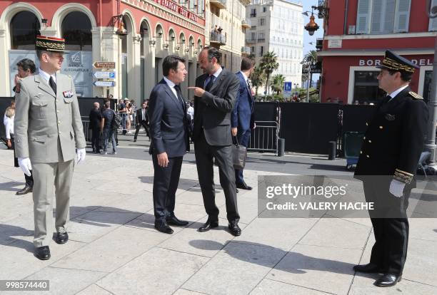 French Prime Minister Edouard Philippe speaks with The Mayor of Nice Christian Estrosi as he arrives in Nice on July 14 to attend a ceremony for the...