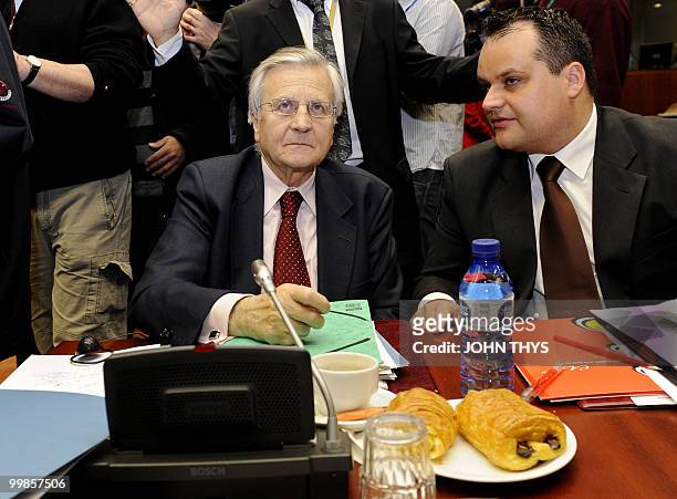 President of the European Central Bank Jean-Claude Trichet talks with an unidentified advisor prior to an Economic and Financial Affairs meeting at...