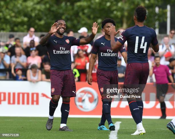 Alexandre Lacazette celebrates scoring a goal for Arsenal with Pierre-Emerick Aubameyang during the match between Borehamwood and Arsenal at Meadow...