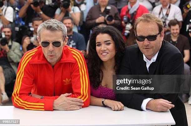 Director Xavier Beauvois, Actress Sabrina Ouazani and actor Lambert Wilson attend "Of Gods And Men" Photocall at the Palais des Festivals during the...