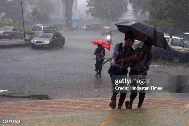 People stuck during the rain at Kharghar, on July 13, 2018 in Mumbai, India. Heavy rains made a comeback in Mumbai causing waterlogging in many parts...