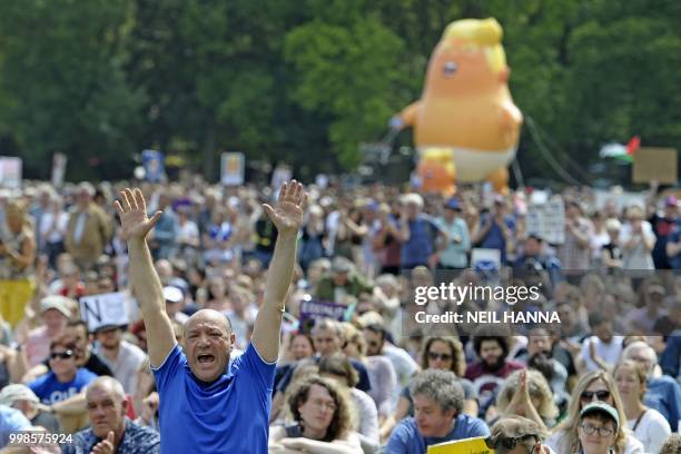 Giant balloon depicting US President Donald Trump as an orange baby is launched as protesters gather in the Meadows, after taking part in the...