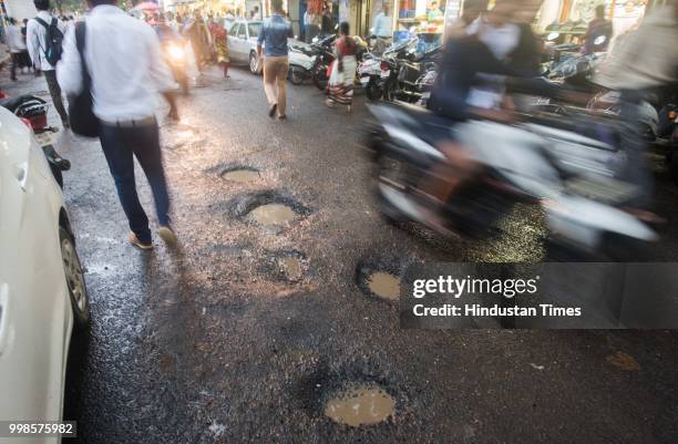 The recent heavy spell of showers has increased the problem of commuters as huge potholes have appeared on various roads in the city after rain at...