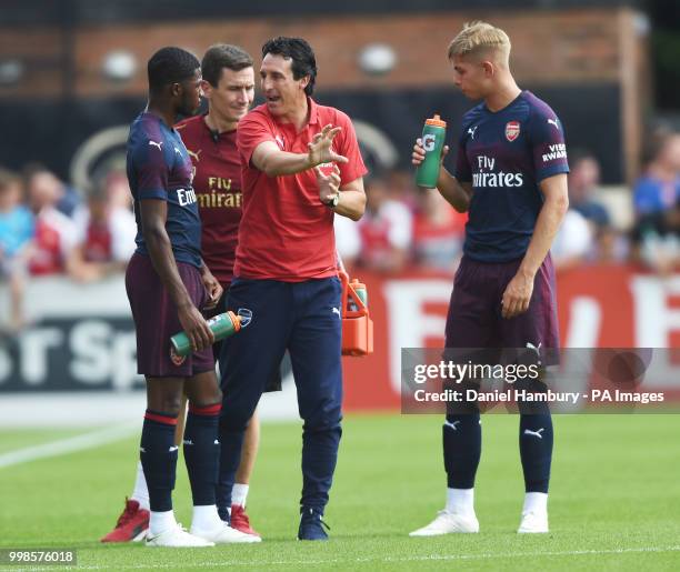 Arsenal manager Unai Emery gives instructions to Ainsley Maitland-Niles as Emile Smith Rowe looks on during the pre-season match at Meadow Park,...