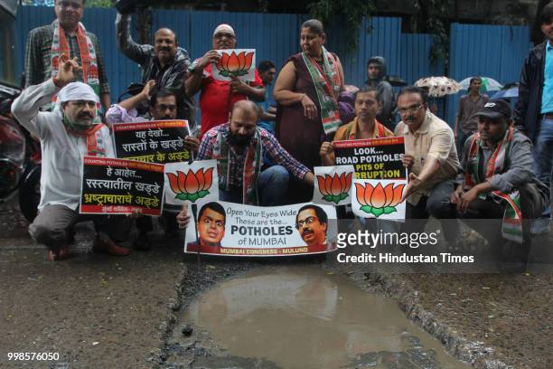 Mulund Congress workers protest against potholes, appeared on the roads after monsoon rains at Panchrasta Mulund, on July 13, 2018 in Mumbai, India.