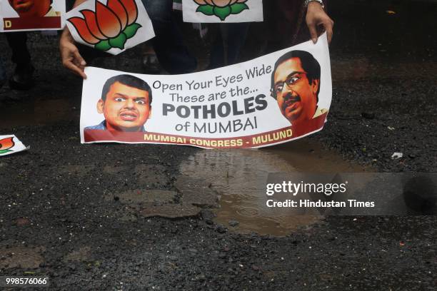 Mulund Congress workers protest against potholes, appeared on the roads after monsoon rains at Panchrasta Mulund, on July 13, 2018 in Mumbai, India.