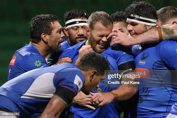 Chris Heiberg of the Force is congratulated by team mates after crossing for try during the World Series Rugby match between the Force and Samoa at...