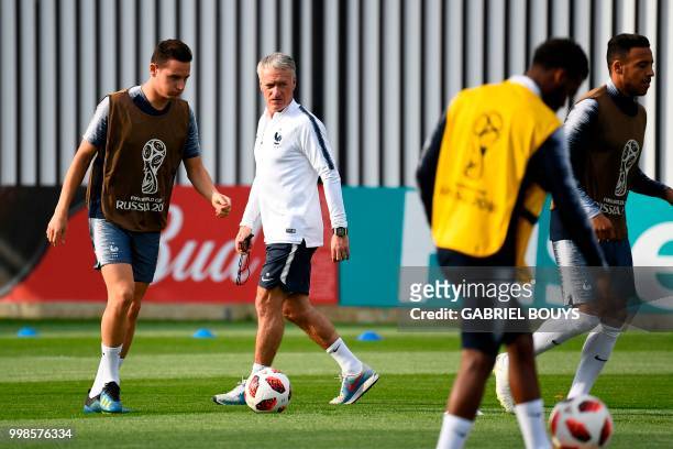 France's coach Didier Deschamps observes France's forward Florian Thauvin and France's midfielder Corentin Tolisso during a training session at the...