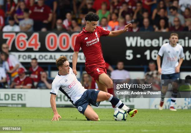 Curtis Jones of Liverpool competes with Callum Styles of Bury during the Pre-Season friendly match between Bury and Liverpool at Gigg Lane on July...